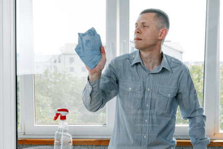 a man washes the windows. House cleaningの写真素材