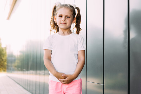 little girl in white t-shirt. space for your logo or design. Mockup for printの写真素材