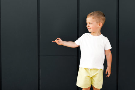 little boy in white t-shirt. space for your logo or design. Mockup for printの写真素材