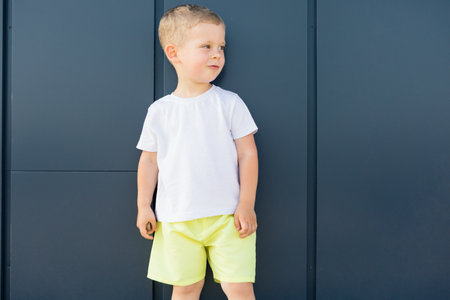 little boy in white t-shirt. space for your logo or design. Mockup for printの写真素材