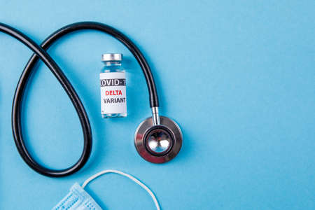 Vaccine bottles covid - 19 delta variant, vials medicine and syringe injection isolated on blue....