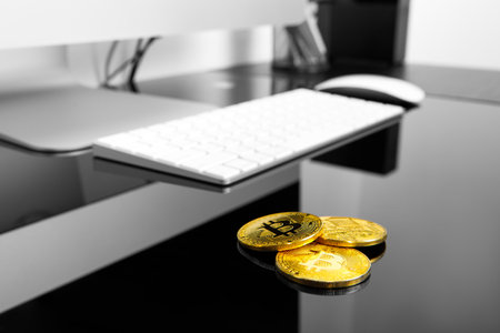 man holding bitcoin coin in hand on wood backgroundの写真素材