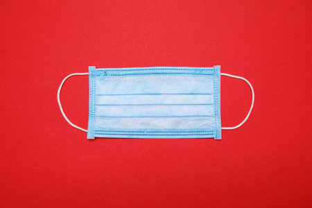 medical mask isolated on red background. Christmas composition.