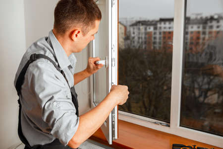The worker installing and checking window in the houseの写真素材