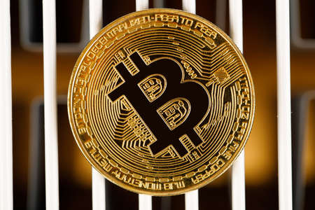 gold bitcoin against the background of the stock price chart