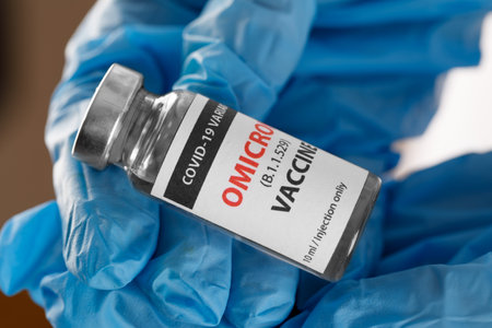 covid 19 OMICRON Variant vaccine in hand on the white background.の写真素材