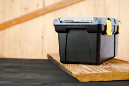 a box with repair tools on a wooden table.の写真素材