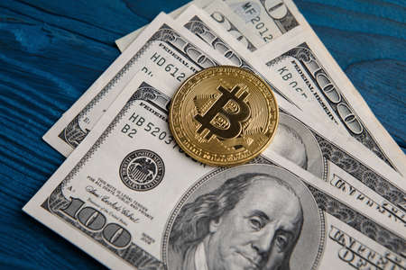 golden bitcoin coin on us dollars close up. Electronic crypto currency.の写真素材