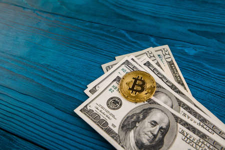 golden bitcoin coin on us dollars close up. Electronic crypto currency.の写真素材