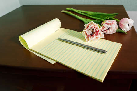 flowers notepad and coffee on the table. valentines day concept.