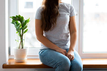 Woman wearing white blank t-shirt with space for your logo, mock up for design indoors.の写真素材