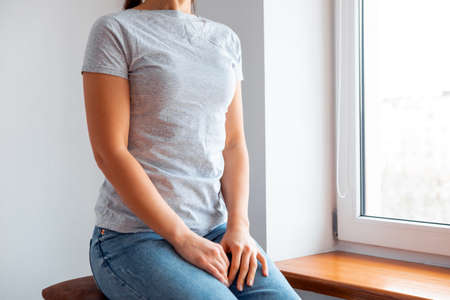 Woman wearing white blank t-shirt with space for your logo, mock up for design indoors.の写真素材