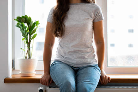 Woman wearing white blank t-shirt with space for your logo, mock up for design indoors.の写真素材