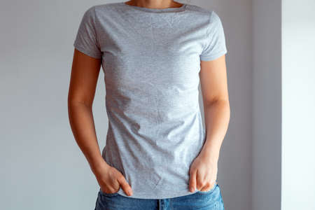 Woman wearing white blank t-shirt with space for your logo, mock up for design indoors.の写真素材