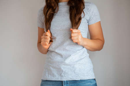Woman wearing white blank t-shirt with space for your logo, mock up for design indoors.の写真素材