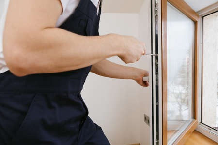 The worker installing and checking window in the houseの写真素材
