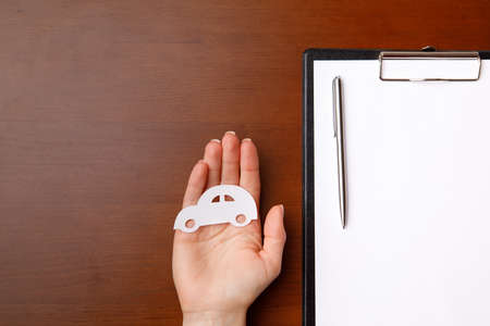Life and home car insurance. business concept covered with hands.