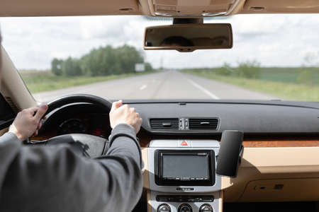 The man driving the modern car.