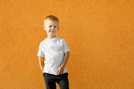 little boy in white t-shirt. space for your logo or design. Mockup for printの写真素材