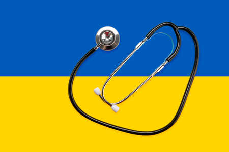 Stethoscope on the national flag of Ukraine blue and yellow, war in Ukraine, medical care in the warの写真素材