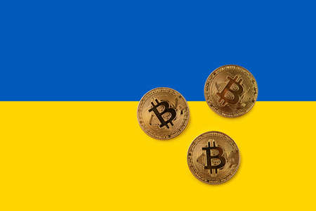 Bitcoin with Ukraine flag blue and yellow background. Electronic crypto currencyの写真素材
