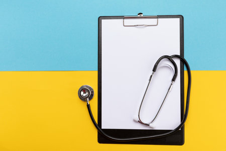 Stethoscope on the national flag of Ukraine blue and yellow, war in Ukraine, medical care in the warの写真素材
