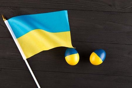easter egg with the flag of Ukraine on a wooden background. no war in Ukraineの写真素材