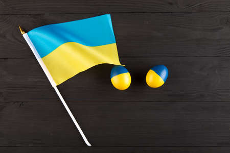 easter egg with the flag of Ukraine on a wooden background. no war in Ukraineの写真素材