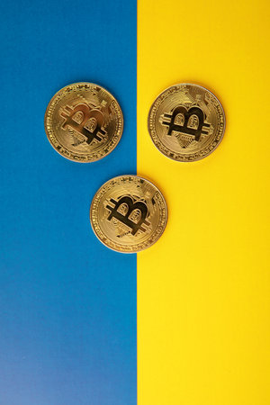 Bitcoin with Ukraine flag blue and yellow background. Electronic crypto currencyの写真素材
