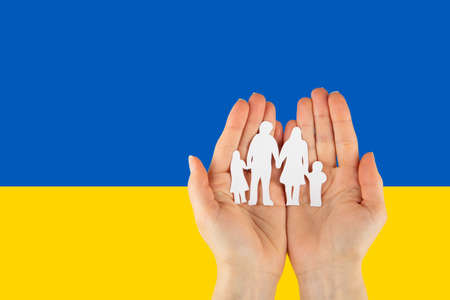 There is no war. People cut out of paper on a blue and yellow background. conceptual war in Ukraineの写真素材