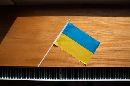 flag of ukraine blue yellow on table wooden background.