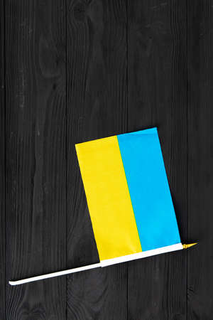 flag of ukraine blue yellow on black wooden background.の写真素材
