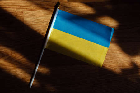 flag of ukraine blue yellow on table wooden background.の写真素材