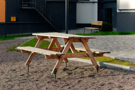 Open gazebo with benches on the lawn with lanterns near the road.の写真素材