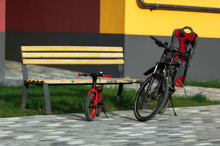 bicycles for adults and children stand next to each other.