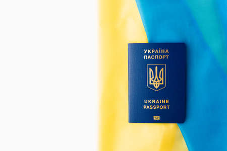 international passport of ukraine against the background of the national flag. war on ukraineの写真素材