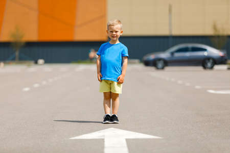 a boy in a blue and yellow t-shirt on the background of the street. national flag of ukraine. Mockup for printの写真素材