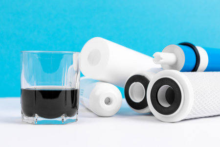 filter cartridges for water on a bright blue background. Installation of reverse osmosis water purification system.の写真素材