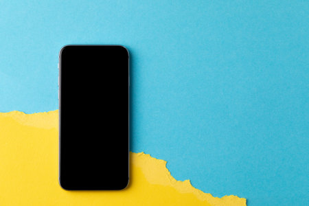 empty screen mobile phone on the background of the flag of ukraine.の写真素材