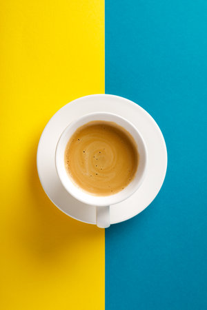 Black coffee in a cup on Ukraine flag blue and yellow background.の写真素材