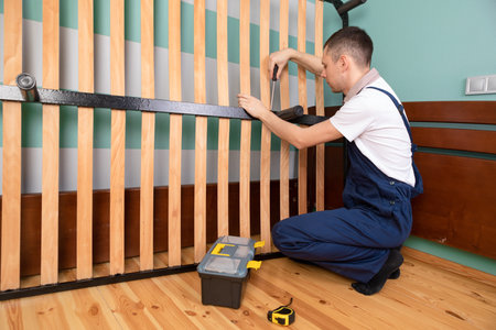 Man assembling sofa furniture at home.の写真素材