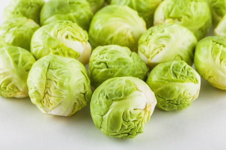 High angle shot of a large group of brussels sprouts on white backgroundの写真素材