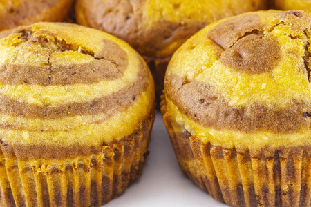 Close up shot of a medium group of muffins on whiteの写真素材
