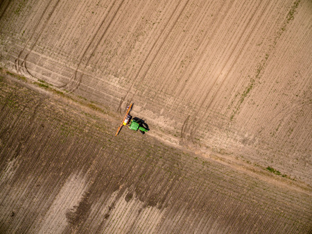 Aerial view on an agricultural crops sprayer in a fieldの写真素材