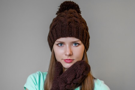 Beautiful young girl in winter cap and mittensの写真素材