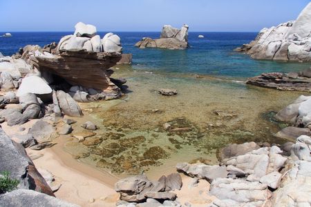 View of a little wild cove surrounded by granite rock の写真素材