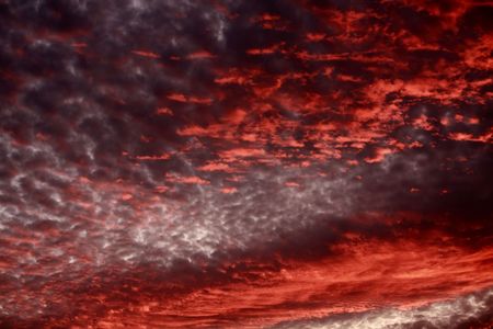 Dramatic sky at sunset with strong color, soft clouds and atmospheric effectsの写真素材