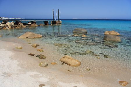 View of a beautiful beach with wooden pierの写真素材