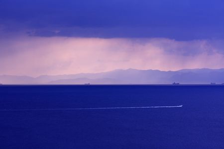 Boat sailing on the sea during the rainの写真素材