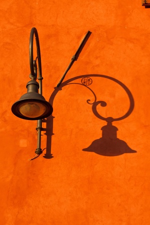 City old lamp with shadowの写真素材